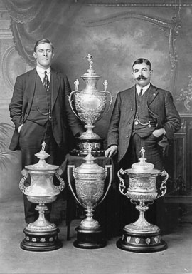 Harold-Wagstaff-captain-and-Albert-Bennett-trainer-with-all-four-cups-1914-15.jpg